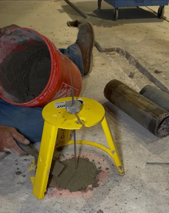 Filling a core hole around a HoleMole Stand on a Troop Contracting jobsite
